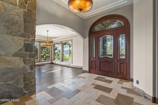 a view of an entryway with wooden floor