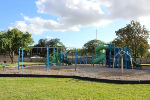 a view of outdoor space with playground and green space