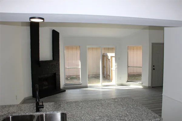 a kitchen with granite countertop a sink a stove and microwave