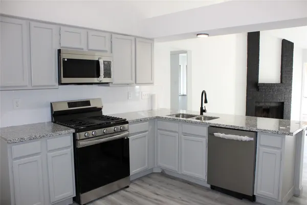 a stove top oven sitting inside of a kitchen