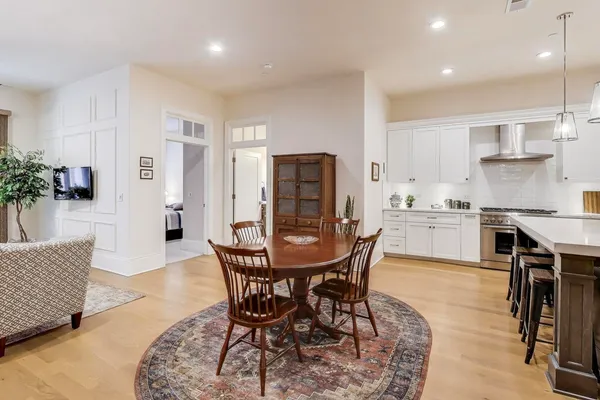 a kitchen with a sink a center island stainless steel appliances and cabinets