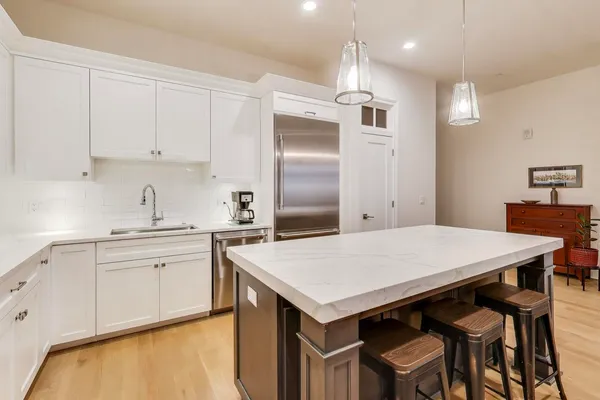 a large kitchen with a large counter top appliances and cabinets