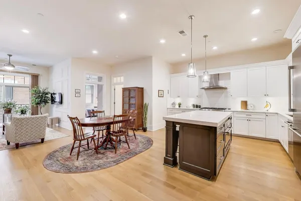 a spacious bedroom with a bed a table and windows