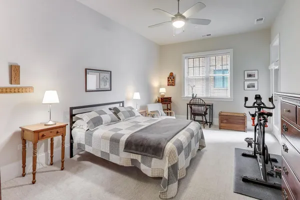 a bedroom with a bed and a table with lamp