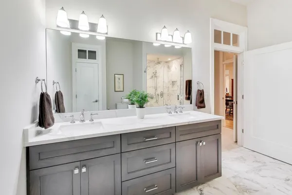 a spacious bathroom with a glass shower door and a sink