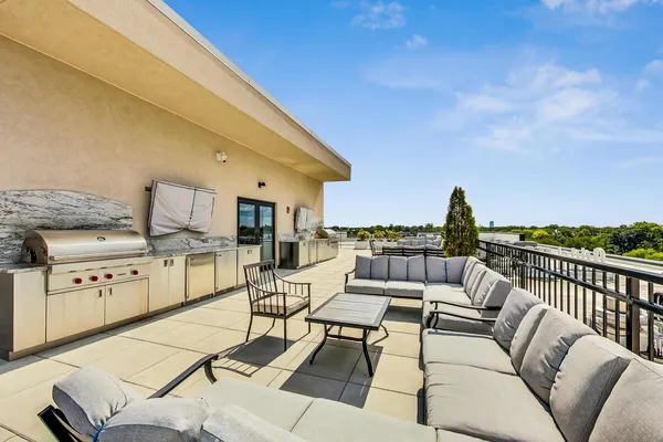 a terrace with outdoor seating and barbeque oven