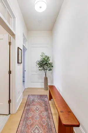 a living room with furniture potted plant and a window