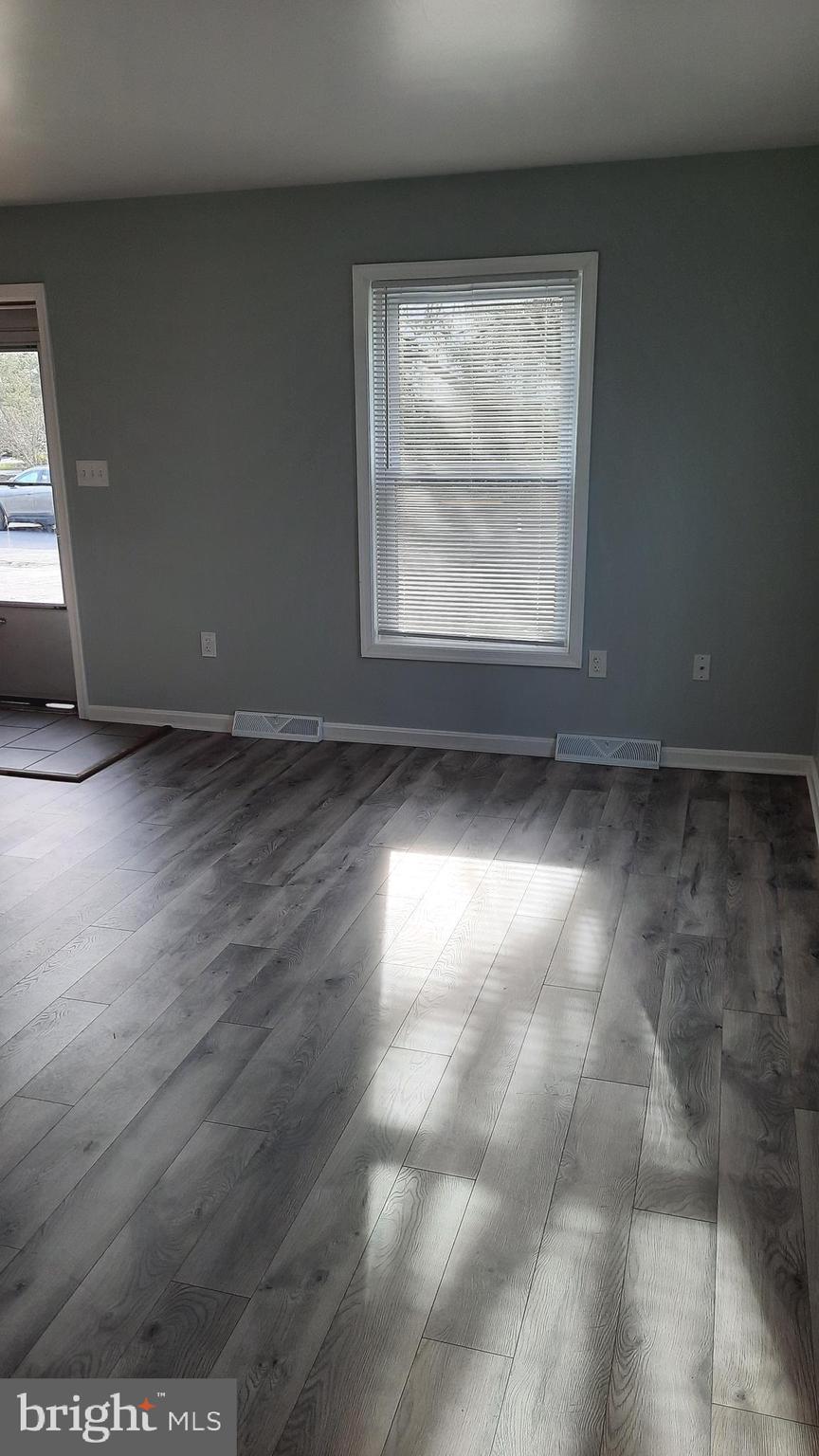 618 Colonial View Road Mechanicsburg, PA 17055 - Photo 11 of 23 an empty room with wooden floor and windows