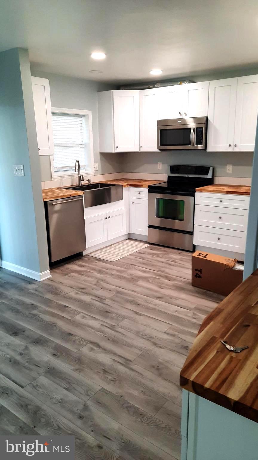 618 Colonial View Road Mechanicsburg, PA 17055 - Photo 3 of 23 a large kitchen with wooden floors and stainless steel appliances