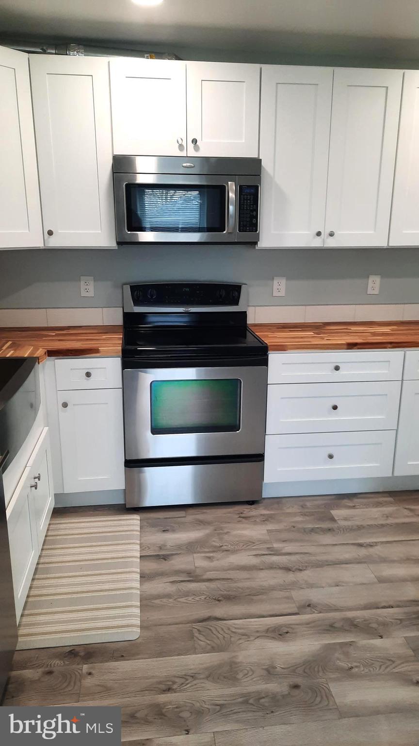 618 Colonial View Road Mechanicsburg, PA 17055 - Photo 4 of 23 a kitchen with granite countertop white cabinets and a stove