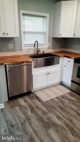 a kitchen with granite countertop a sink and cabinets