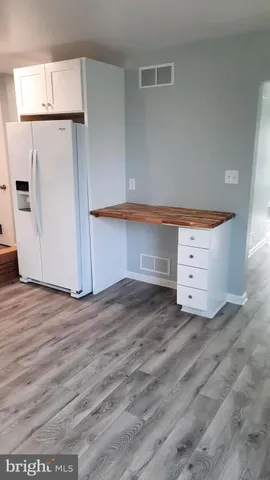 an empty room with wooden floor