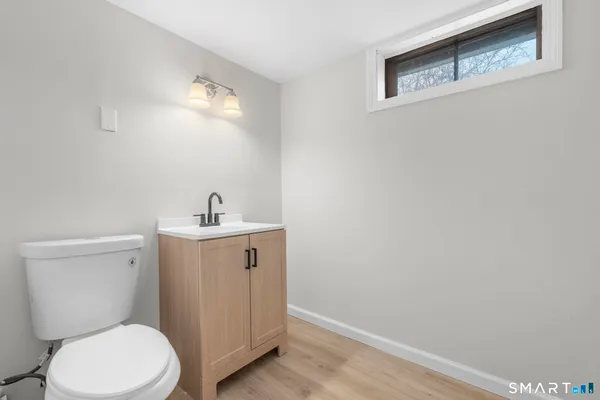 a white toilet sitting next to a bathroom sink