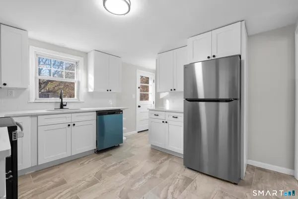 a kitchen with stainless steel appliances a refrigerator sink and cabinets