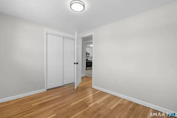 a view of an empty room and wooden floor
