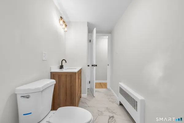 a white toilet sitting next to a bathroom sink