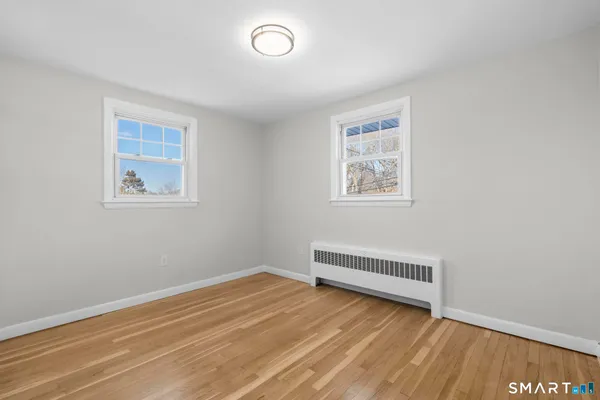 a view of room with window and wooden floor