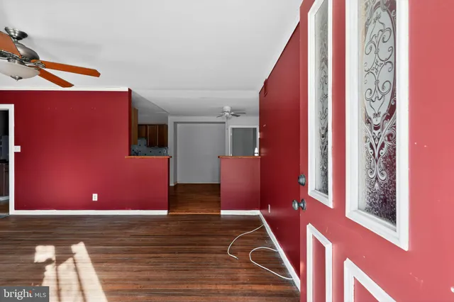 a view of a livingroom with wooden floor and stairs