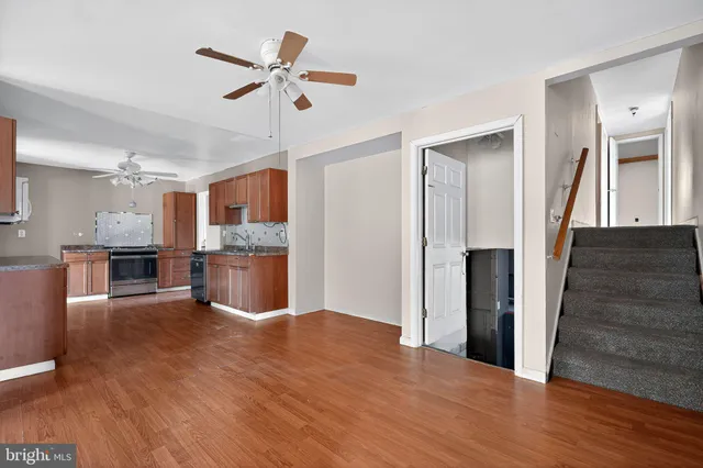 a view of kitchen with cabinets and wooden floor