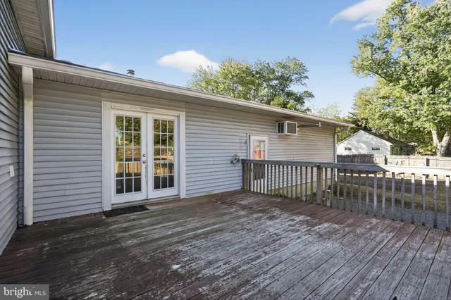 a view of a house with a wooden deck