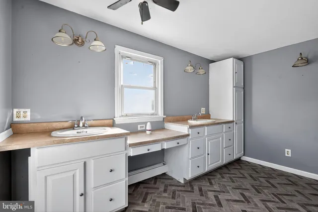 a bathroom with a double vanity sink mirror and