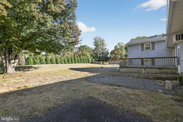 a view of a yard with wooden fence