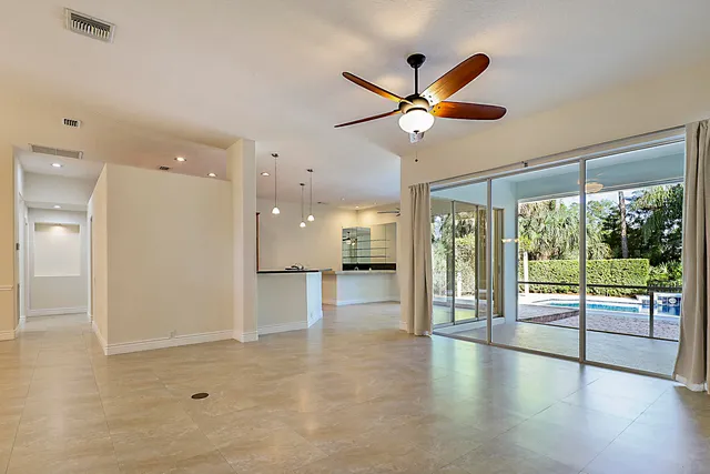 a open kitchen with stainless steel appliances granite countertop a refrigerator a oven and a sink with granite countertops