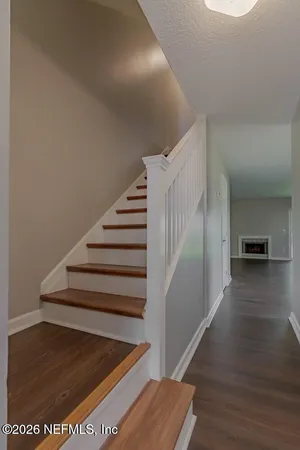 a view of entryway and hall with wooden floor