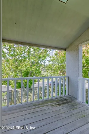 a view of a balcony with wooden floor