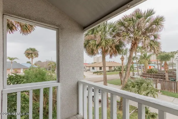 a view of balcony with wooden floor