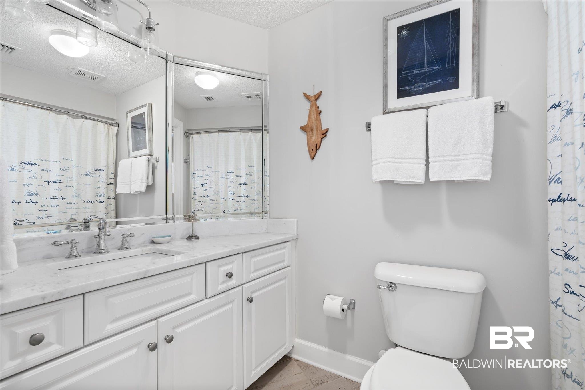 27582 Canal Road, Unit 2611 Orange Beach, AL 36561 - Photo 22 of 37 Bathroom with vanity, toilet, and a textured ceiling