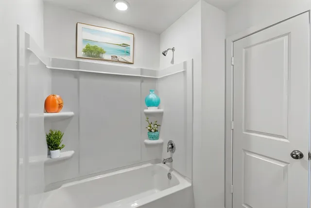 a bathroom with a bathtub and a window