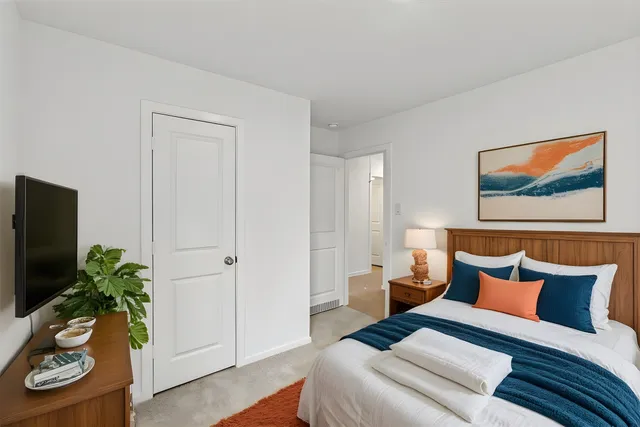 a bedroom with furniture and a potted plant