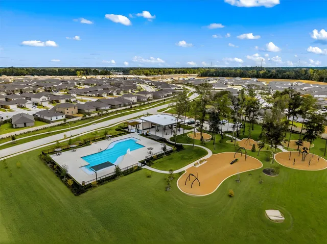 an aerial view of a house with a garden and outdoor seating