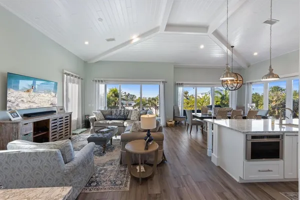 a kitchen with granite countertop white cabinets and stainless steel appliances