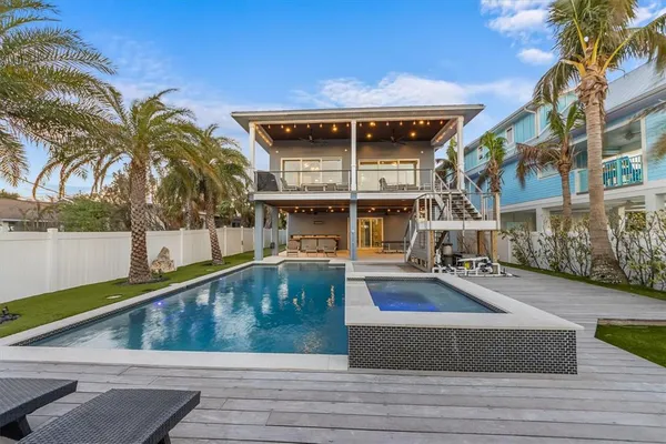 an aerial view of a city with ocean view in back