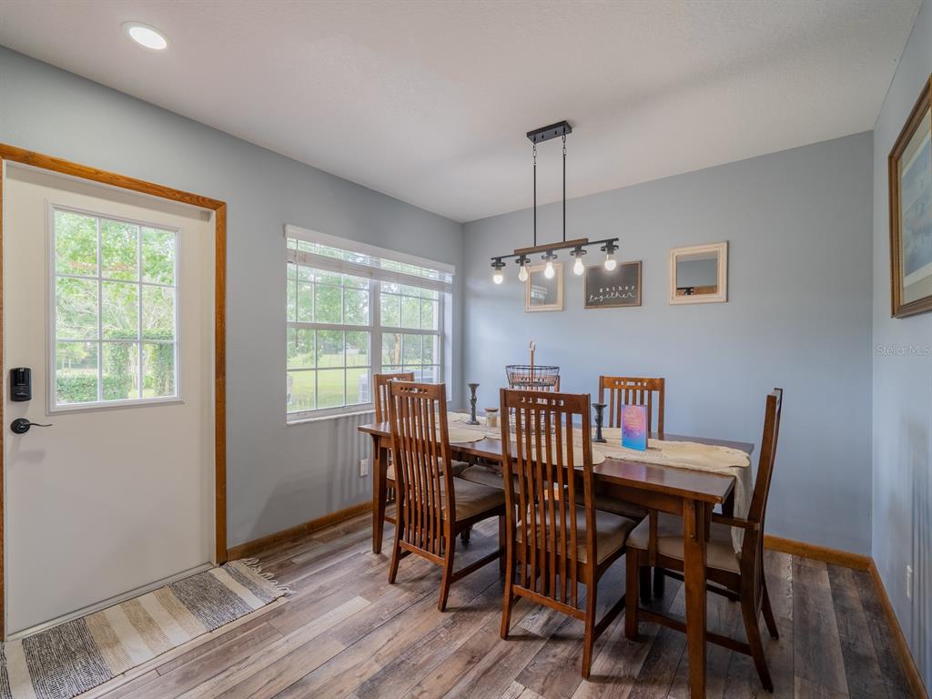 4381 Northeast 105th Place Anthony, FL 32617 - Photo 10 of 49 a view of a dining room with furniture window and wooden floor