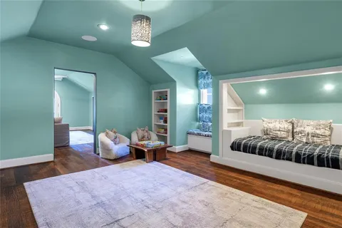 a bedroom with a large bed and a chandelier