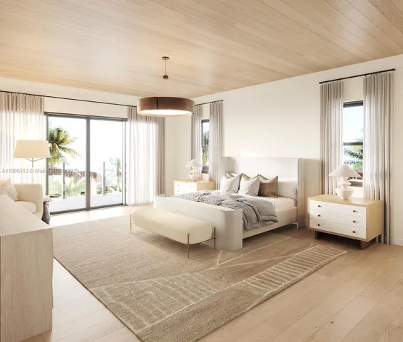 a spacious bedroom with a large window and a table