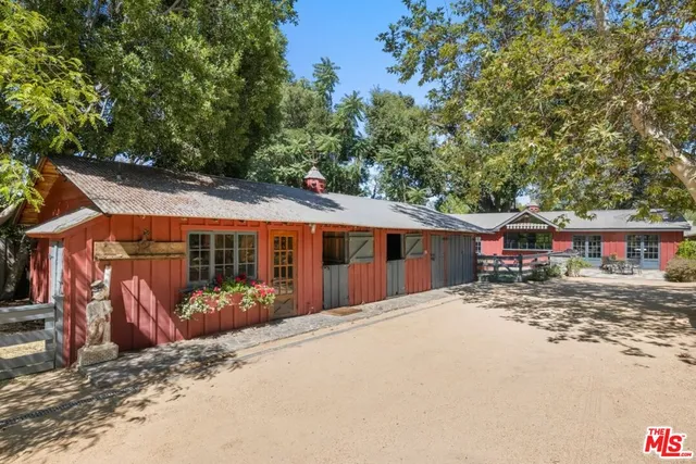 a living room with fireplace furniture and a large window
