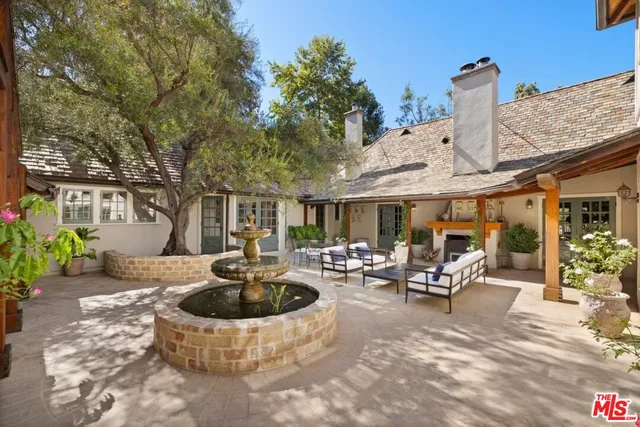 a view of a patio with a table and chairs