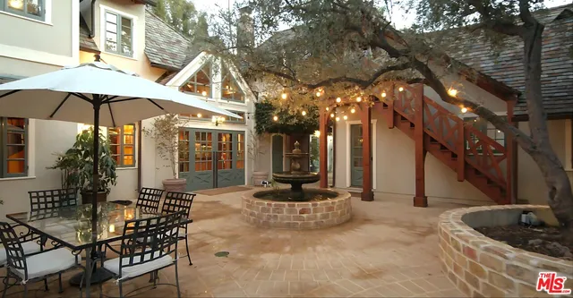 a bedroom with a bed and a dresser next to a window