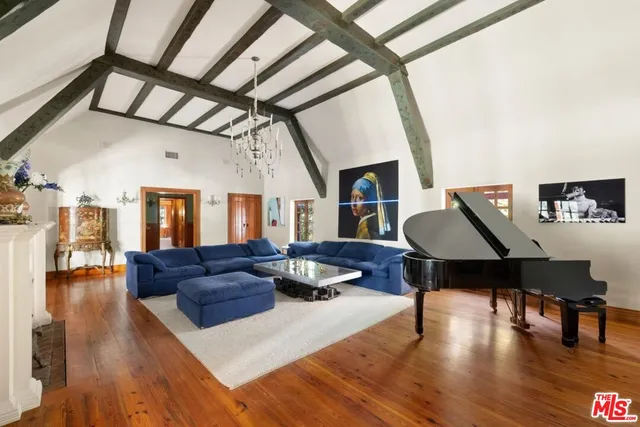 a room with lots of furniture and wooden floor