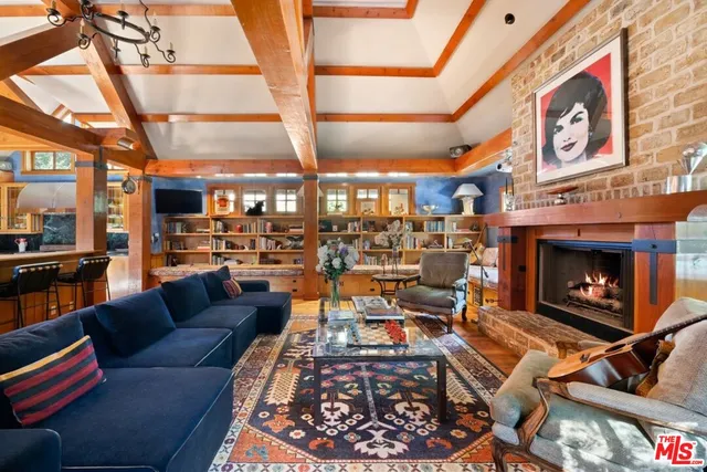 a view of a living room with a fireplace