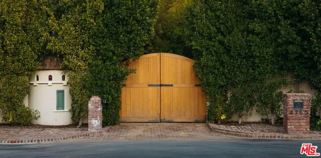 a view of a park with large trees