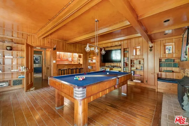 a view of a kitchen with wooden floor and a sink