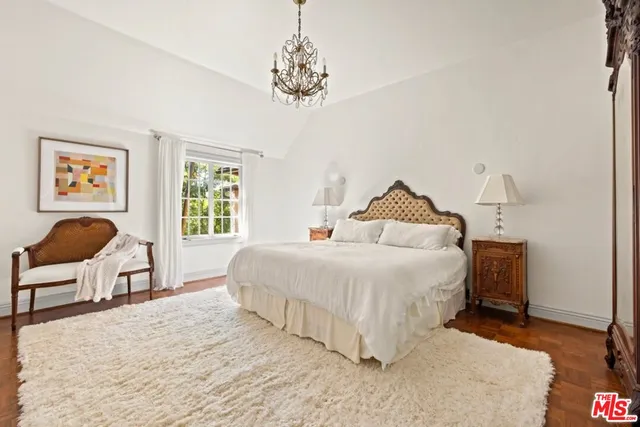 a living room with furniture a flat screen tv and a large window