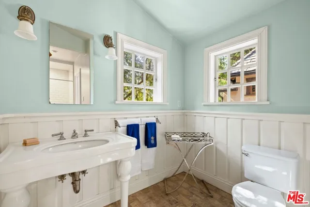 a living room with furniture a flat screen tv and a table