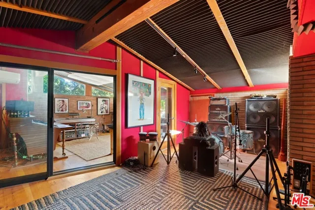 a bedroom with furniture and a large window