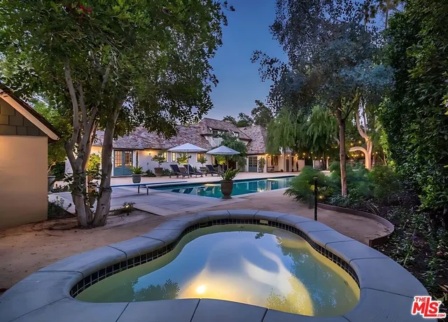 an aerial view of a house with a yard and lake view